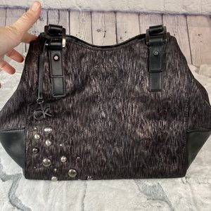 Calvin Klein hobo bag black fabric with silver thin lines with leather accents.